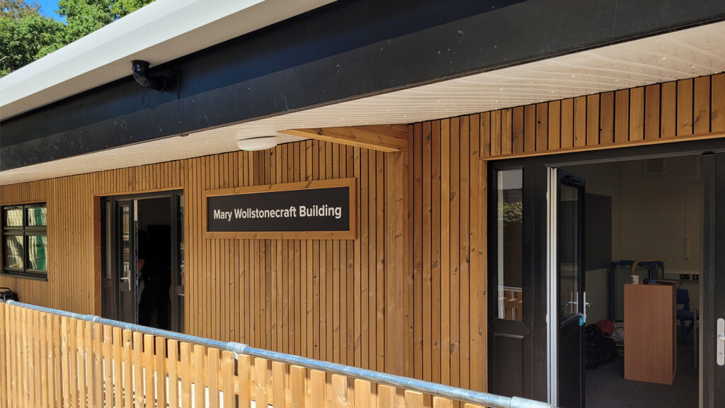 Contemporary timber-clad classroom block at Eccles Aurora School, designed by Norfolk architects Paul Robinson Partnership, featuring a covered walkway and purpose-built facilities tailored for non-mainstream education