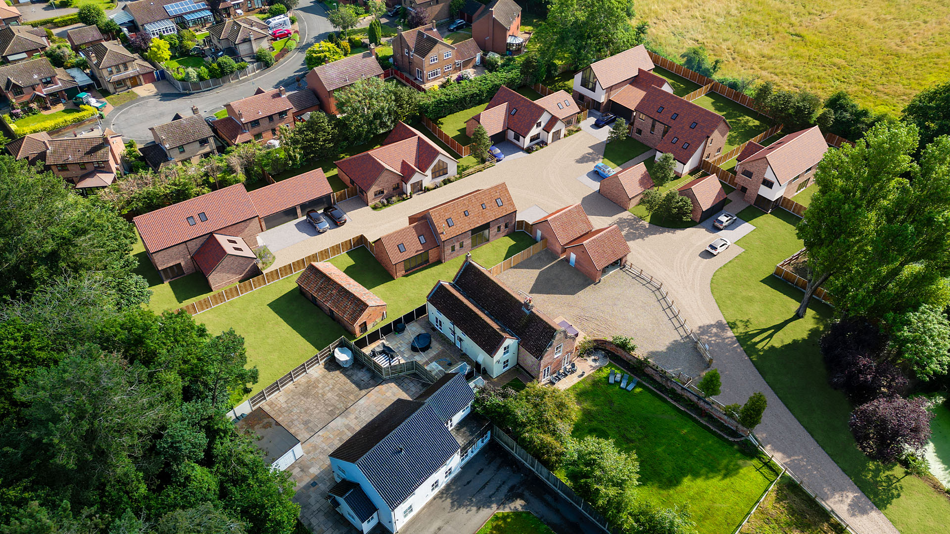 Aerial view of Dairy Farm development in Ormesby St Margaret, Norfolk, designed by leading Norfolk architects Paul Robinson Partnership. The image highlights six new builds, a barn conversion, and outbuildings, showcasing the firm's expertise in rural architecture and planning.