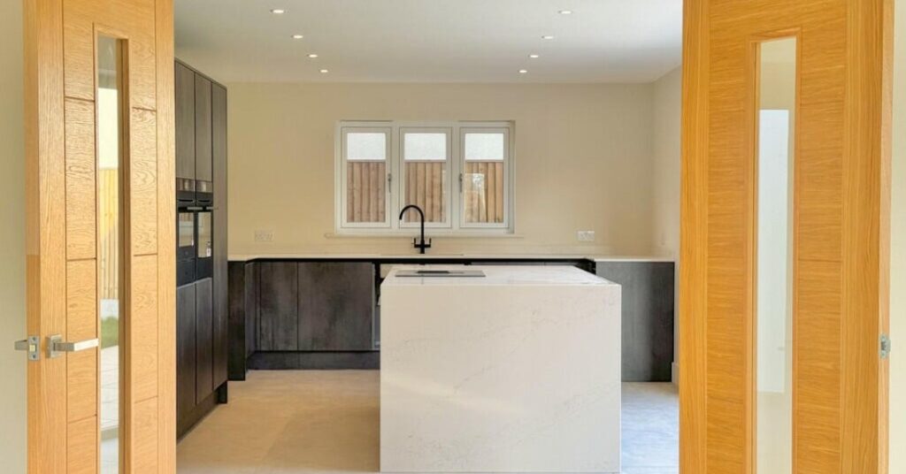 Contemporary kitchen interior at Dairy Farm development in Ormesby St Margaret, Norfolk, designed by Norfolk architects Paul Robinson Partnership, featuring modern finishes and open-plan design.